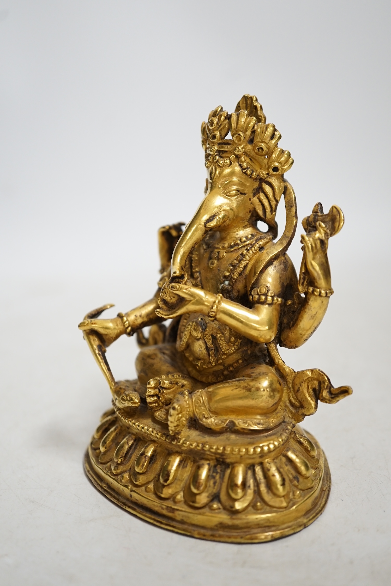 A gilt bronze figure of Ganesha, 13cm high. Condition - fair